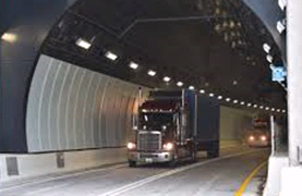 image of semi truck leaving a tunnel
