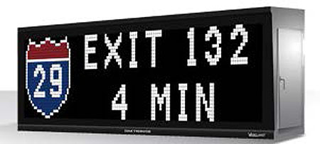 This is an image of a full color dynamic message board. The message on the sign reads: Exit 132 4 min. Next to it on the left is a red, white, and blue route symbol for Rt. 29.