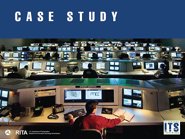 Case Study. A placeholder graphic of a traffic operations center indicating a case study. The image shows a large room with a series of computer work stations in six visible rows leading into the distance. People are seated and working at several workstations. There is a blue rectangle at the top of the image of the traffic operations center with the title “Case Study.” DOT and RITA logo in lower left corner and Standards ITS Training logo in lower right corner.