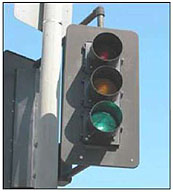 A photo of a traffic signal head with the green light on.