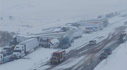 A highway pileup of multiple caused by bad winter snow- weather is shown in the photo.