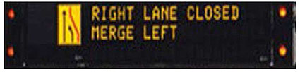 This DMS shows the message RIGHT LANE CLOSED MERGE LEFT and is left justified.
