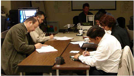 An image of a group of engineers working at a Table is shown at the right bottom corner.