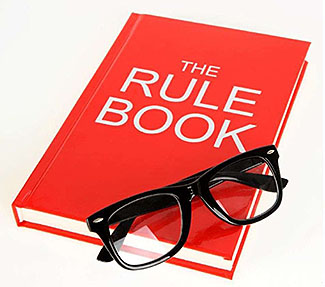 Stock art image of a Rule Book with glasses on top.