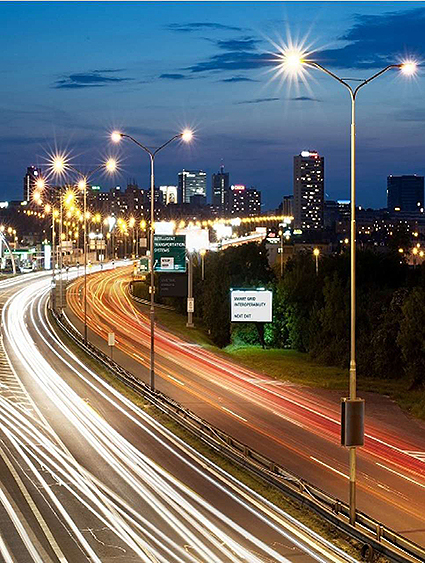 A time-lapse photo of a lighted highway with vehicular traffic.