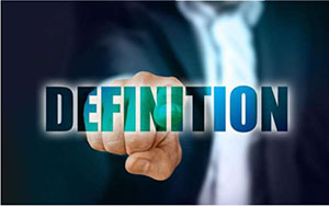 A photograph of a person that is pointing to a word that has been overlaid on the graphic. The word is “definition”.
