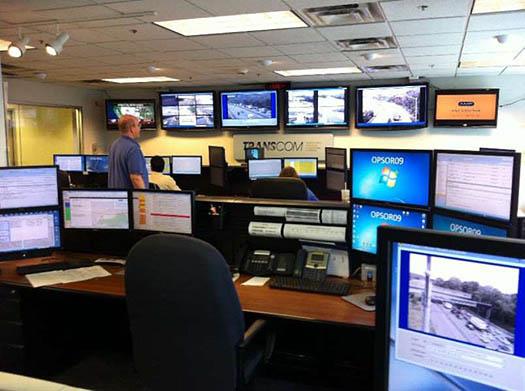Similar to slide 37 above, a photo of Transcom regional TMC is shown. A room and desk with many computer monitors.