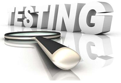 The word “TESTING” is shown as a three-dimensional object along with a magnifying glass.