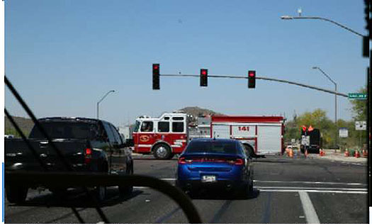 There is a photo of a fire truck going through a signalized intersection. The photo is intended to show emergency vehicle priority/preemption.