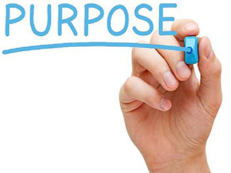 The lower right corner of this slide includes an image of a hand writing the word “Purpose” with a light blue marker.