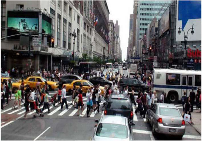 A photo of mixed traffic in New York City is shown to indicate where bus-pedestrians traffic conflicts may occur.