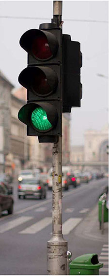 Photo of a traffic signal with the green light illuminated.