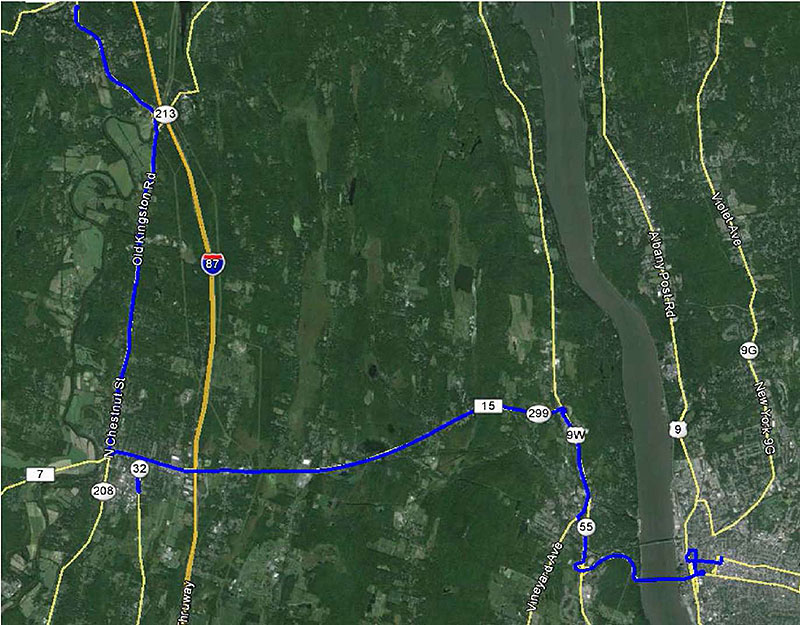 This graphic shows a satellite view of a region of New York State. There is a blue path which shows the route a transit vehicle starting at the northwest corner of the image and moving towards the southeast corner.
