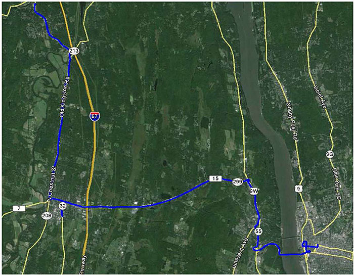 This graphic shows a satellite view of a region of New York State. There is a blue path which shows the route a transit vehicle starting at the northwest corner of the image and moving towards the southeast corner.