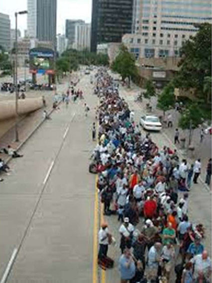 A photo on the right side of the slide that shows hundreds of people lined up waiting for access to the Louisiana Superdome after Hurricane Katrina.