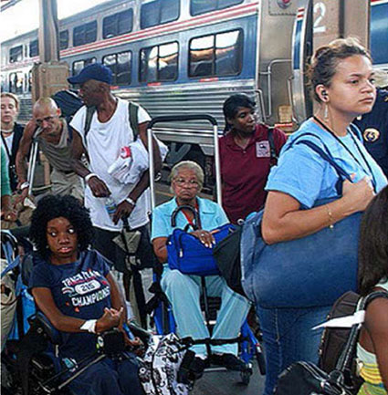 A photo on the left side of the slide that shows people in wheelchairs and on crutches waiting outside of a train.