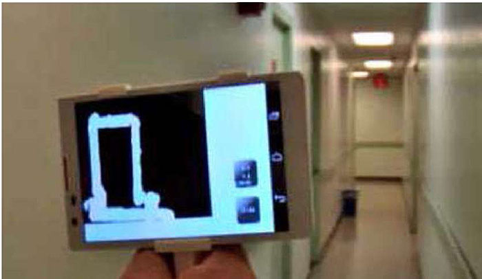 A photo of a wayfinding device being used inside of a building to guide the user.