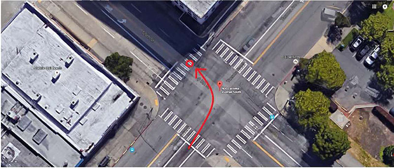 Photo shows an aerial view of the intersection from Google Earth. A red curving arrow depicts the path of the bus turning left through the intersection.