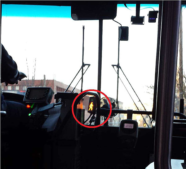 This slide includes a time stamped photo taken from the inside of the bus looking forward. It shows the pedestrian warning indicator illuminated in a red circle.