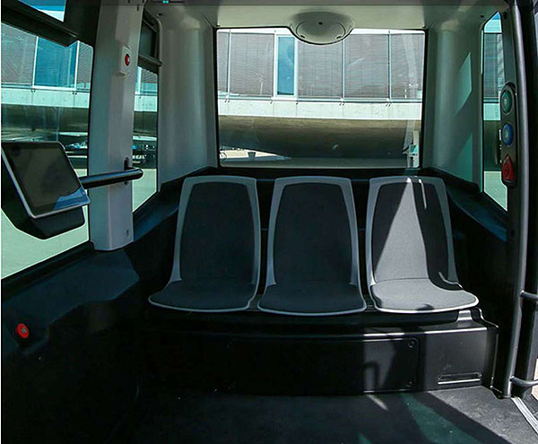 This slide shows the interior of the Easymile EZ10 vehicle with three seats in a row facing the camera.