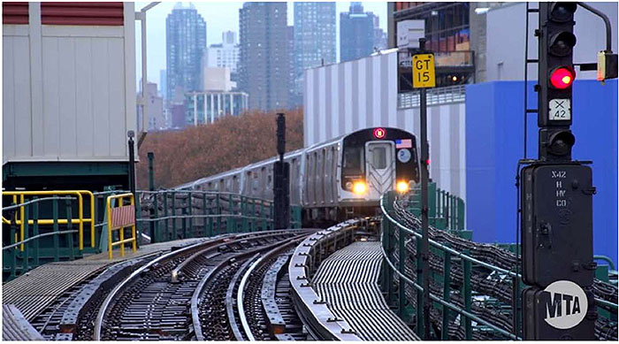 This slide shows a NYCT heavy rail transit train coming toward the camera. The track and signals are shown.