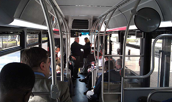 A photo of the interior of a bus with people sitting in the bus.