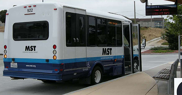 A photo of a transit bus parked in front of a bus stop shelter at the bottom of the slide.