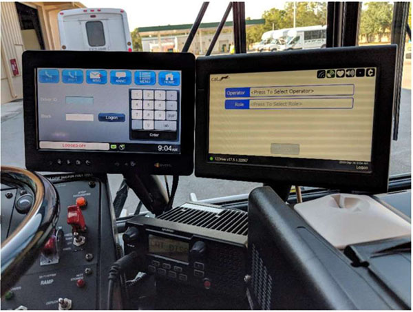 There is a photo on the right-hand side of this slide of two on-board computer display screens to the right of where the bus operator sits.