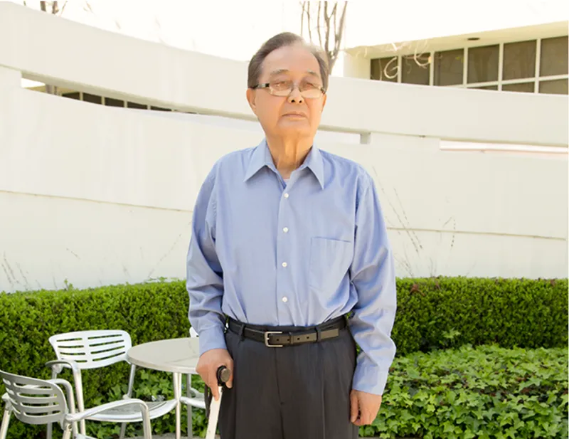 A man standing with a cane