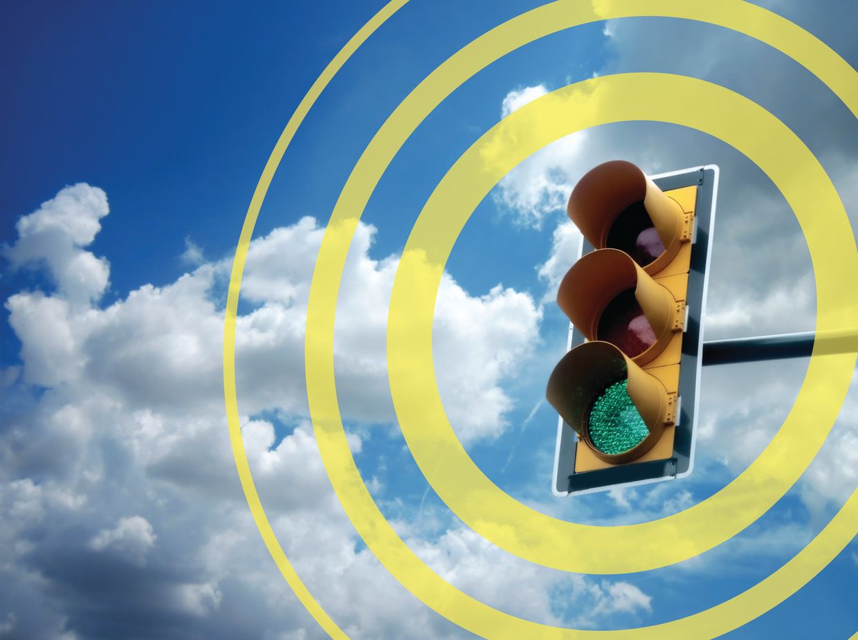 Close-up of a traffic light with yellow circles forming a target ring around it.