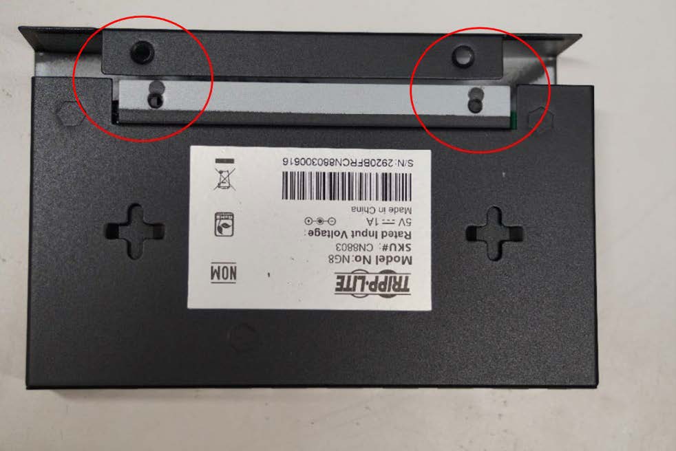 This photo shows the mounting holes of the network switch. The holes are circled in the photo.