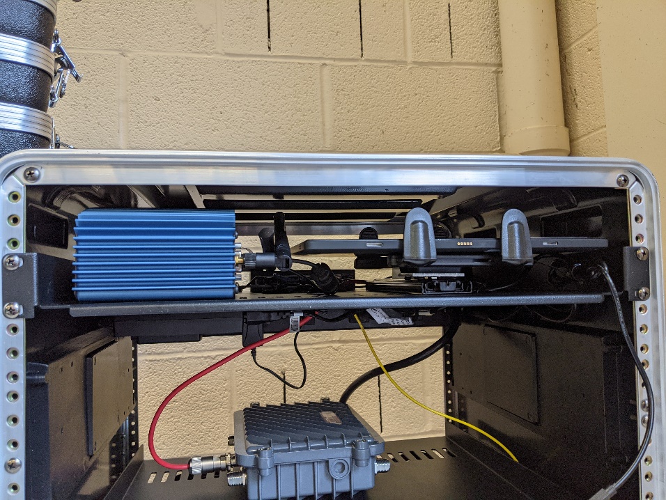 This photo shows the upper shelf of Connected and Automated Vehicle education (CAVe)-in-a-box mounted. 