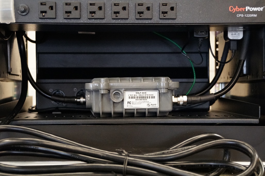 This photo shows the cables running into the roadside unit (RSU) in Connected and Automated Vehicle education (CAVe)-in-a-box.
