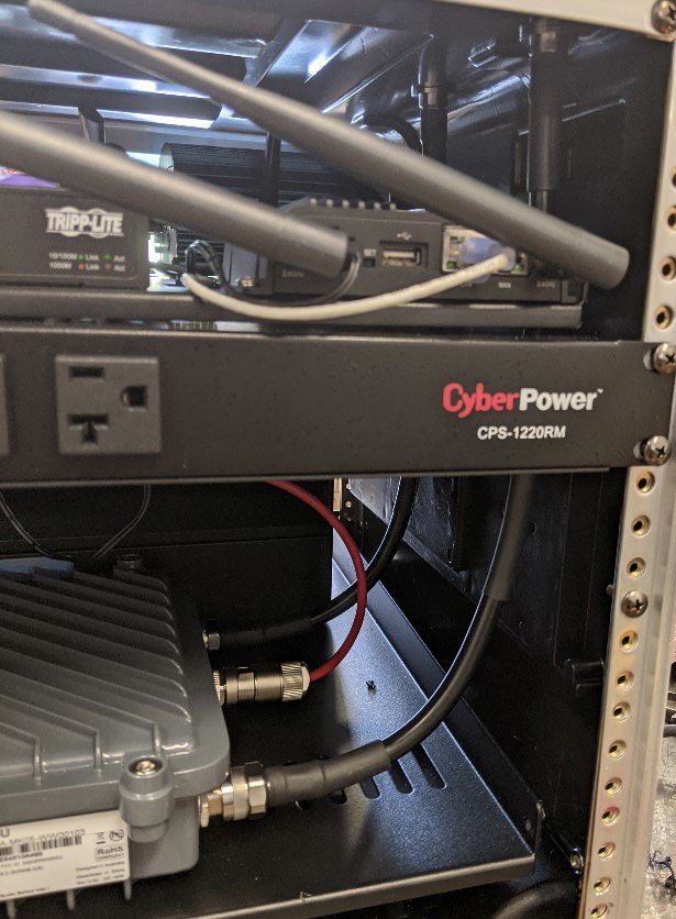 This photo shows how the roadside unit antenna cables are run to the top of the Connected and Automated Vehicle education (CAVe)-in-a-box travel case.