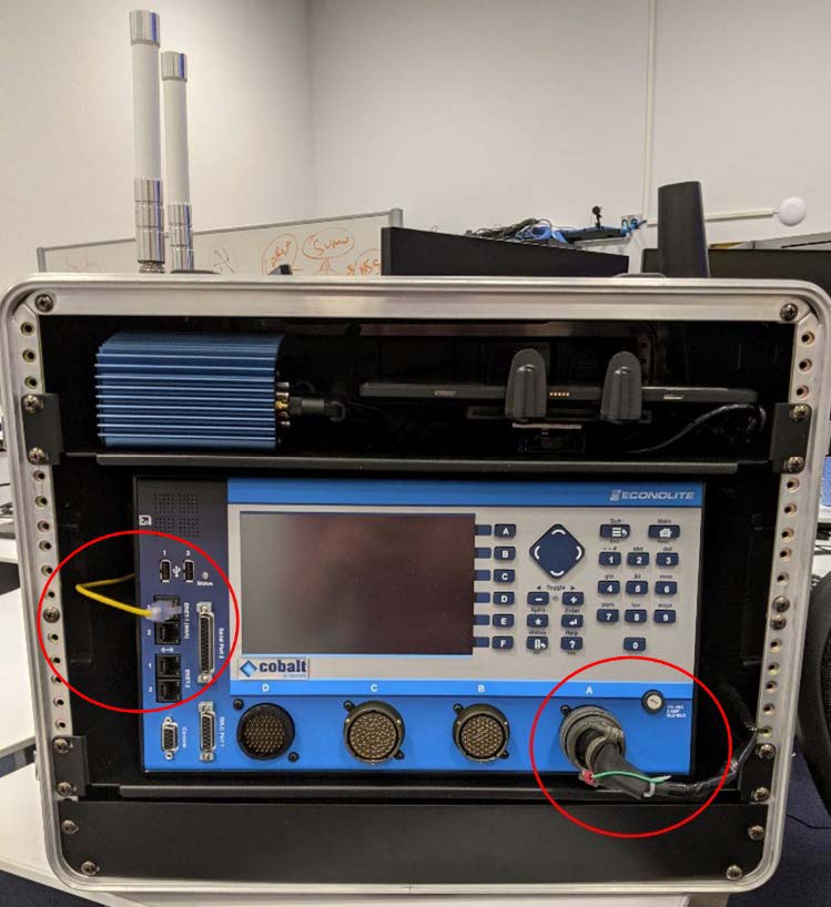This photo shows a completed Connected and Automated Vehicle education (CAVe)-in-a-box unit. The ethernet and power cables are circled.