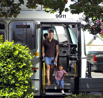 photo of a mother and child getting off a city bus