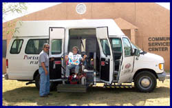 photo of a person in a wheelchair being let off of a passenger van on a lift