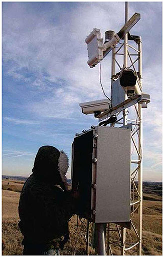 ESS Capabilities: This slide has an image of a technician at the control panel of a weather station in the field. 